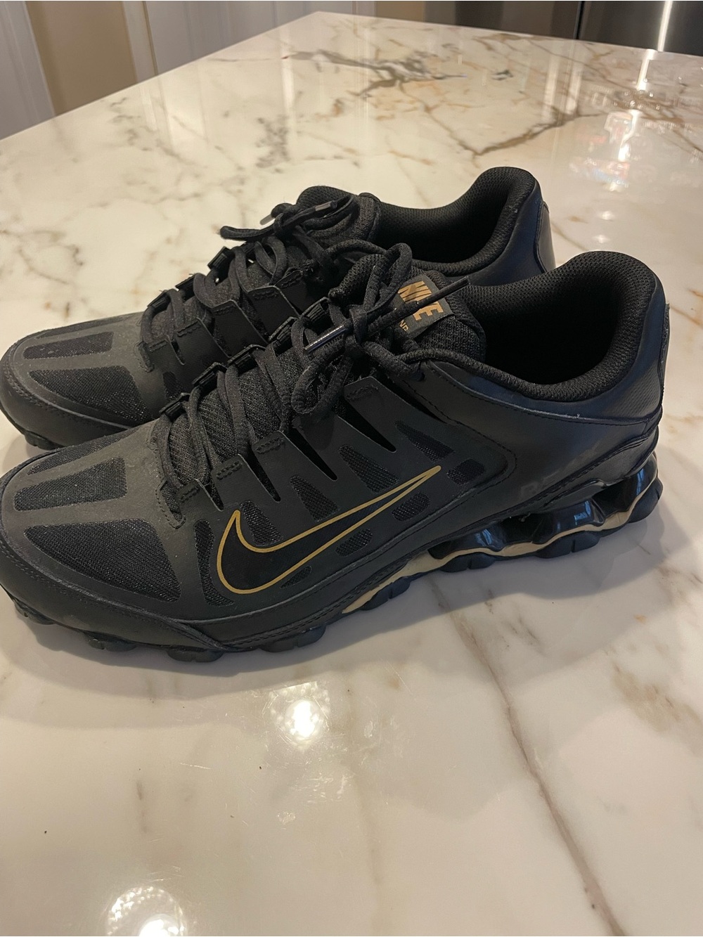 Nike Men’s Black Athletic Shoes with Gold Swoosh Accent